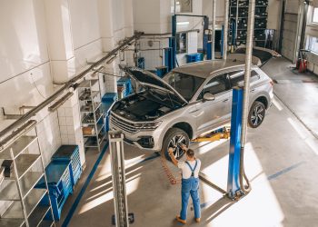 Auto mechanic checking car