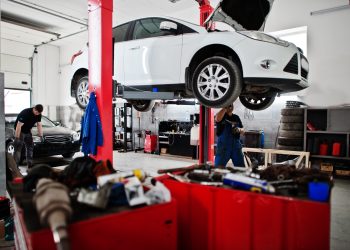 Car repair and maintenance theme. Mechanic in uniform working in auto service.